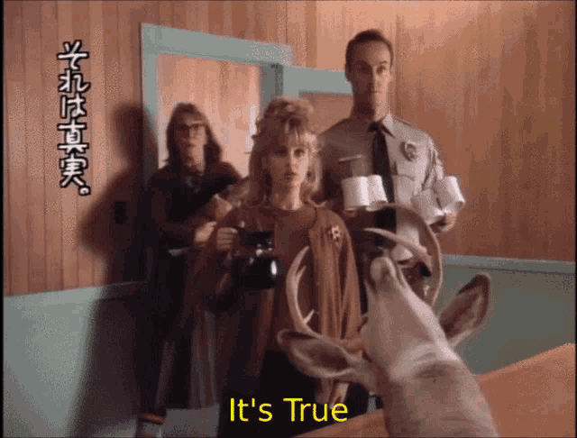 a group of people standing around a deer with the words it 's true above it