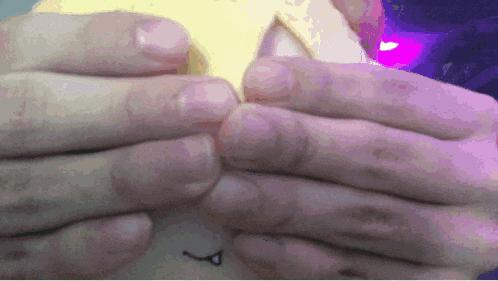 a close up of a person holding a yellow object
