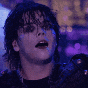 a close up of a person 's face with purple lights behind them