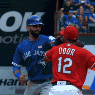 a blue jays player is standing next to a red jays player