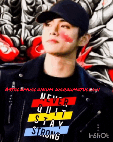 a man wearing a black hat and a shirt that says never quit stay strong