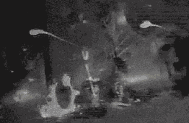 a black and white painting of a fire with a person holding an umbrella