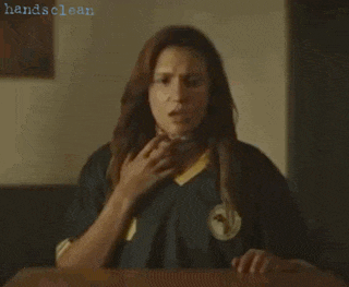 a woman sitting at a table with her hands on her chest and the words handsclean on the bottom right
