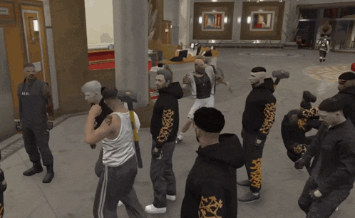 a group of men are standing in a room with one wearing a black hoodie with a leopard print