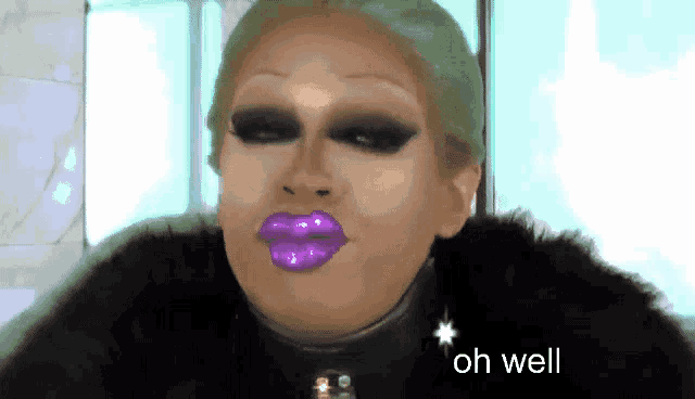 a picture of a drag queen with purple lips and the words oh well below her