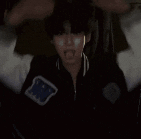 a person wearing a black jacket with a blue patch that says ' army '