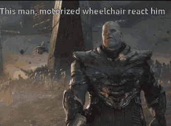 thanos is holding a sword and says this man motorized wheelchair react him in the background