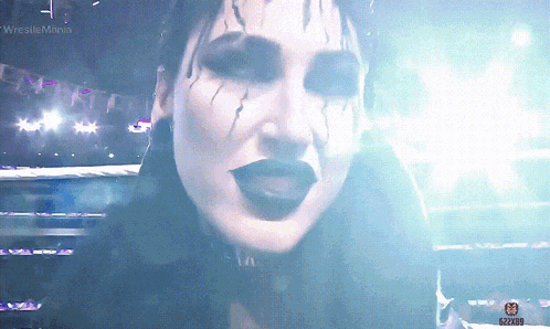 a close up of a woman 's face with the words wrestlemania in the corner