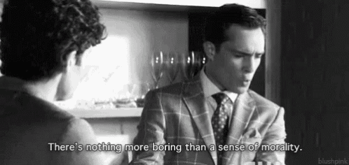 a man in a suit is talking to another man in a black and white photo .