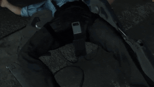 a man in a blue striped shirt is laying on the ground