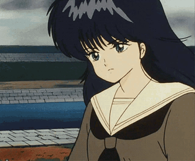 a girl with long black hair and green eyes is wearing a sailor uniform