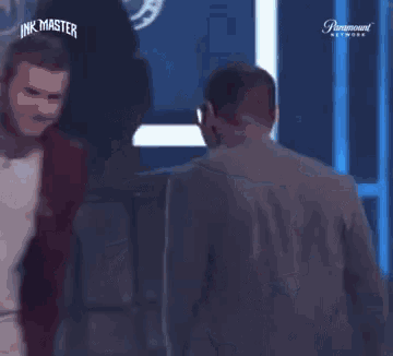 two men hugging in front of a screen that says paramount network
