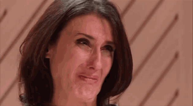 a woman is making a funny face and crying