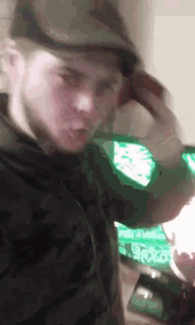 a blurry picture of a man wearing a hat and a jacket