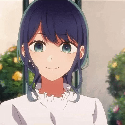 a close up of a girl with blue hair and green eyes smiling .