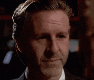 a man with a beard wearing a suit and white shirt