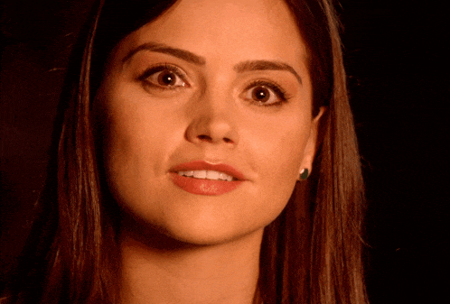 a close up of a woman 's face with a serious look on her face