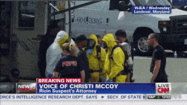 a group of people in yellow suits are standing in front of an ambulance