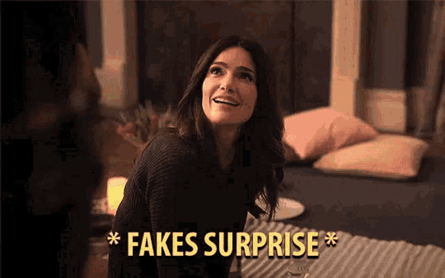 a woman is sitting on a bed with a glass of wine and the words `` fakes surprise '' written above her .