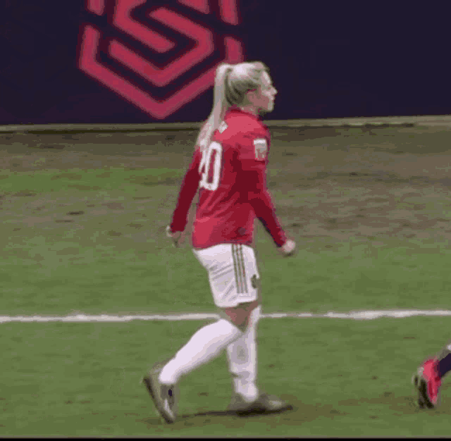 a female soccer player wearing a red number 10 jersey