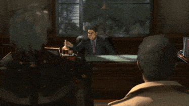 a man in a suit is drinking from a glass
