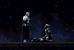 two men standing next to each other in a dark room with stars in the background