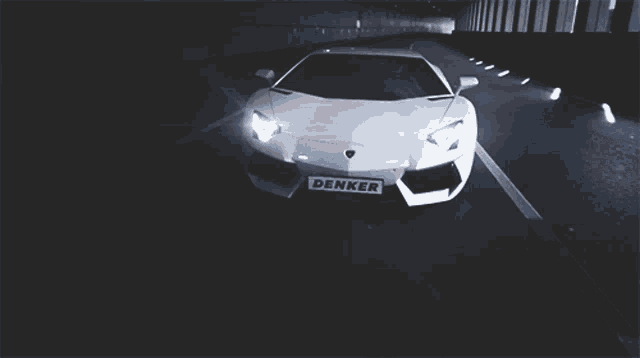 a white car with a denker license plate is driving through a tunnel