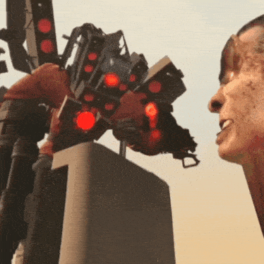 a man is looking up at a robot with red lights on its arms