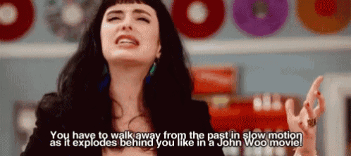 a woman says " you have to walk away from the past in slow motion as it explodes behind you like in john woo movie "