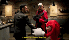 a man in a suit is shaking hands with a cartoon character that says echidna warrior