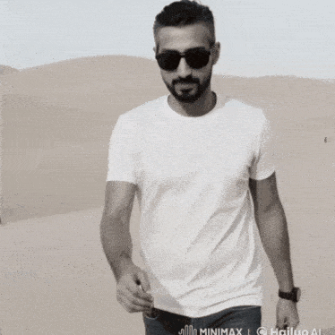 a man wearing sunglasses and a white shirt holds a red heart
