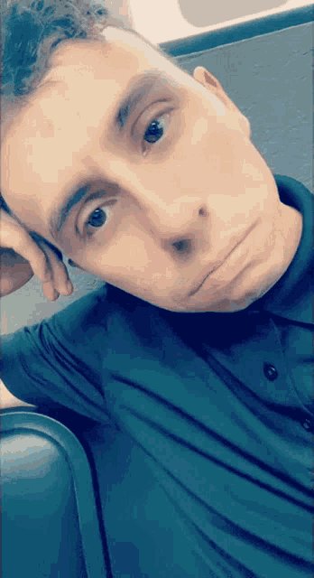 a man in a black shirt is taking a picture of himself