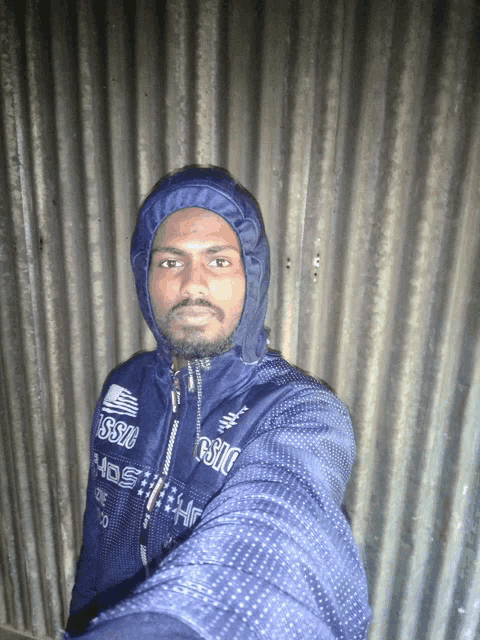 a man wearing a hooded jacket that says esso