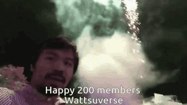 a man is standing in front of a fireworks display with the words happy 200 members wattsuverse written below him