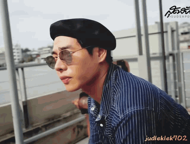 a man wearing a black beret and sunglasses has the name judleklek702 on the bottom