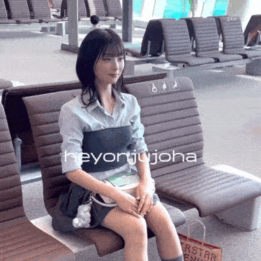 a woman is sitting on a chair with the name heyonjijoha on the bottom