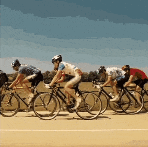 a group of cyclists are racing on a track and one of them is wearing a jersey that says ' a ' on it