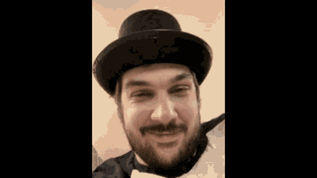 a man with a beard wearing a top hat and a bow tie .