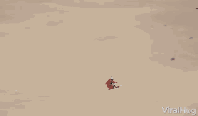 a man on a dirt bike is doing a trick in the air with viralhog written in the bottom right corner