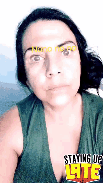 a woman is wearing a green tank top with the words staying up late written on it