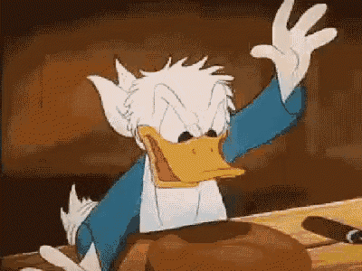 donald duck is sitting at a table smoking a cigar and waving at the camera .