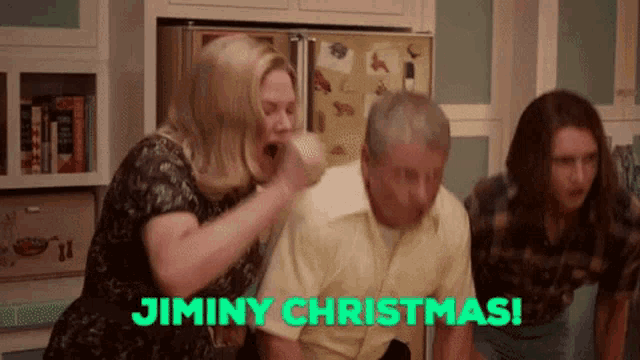 a group of people are sitting in a kitchen with the words jimmy christmas in green letters .