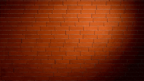a brick wall with a hole in it and bricks coming out