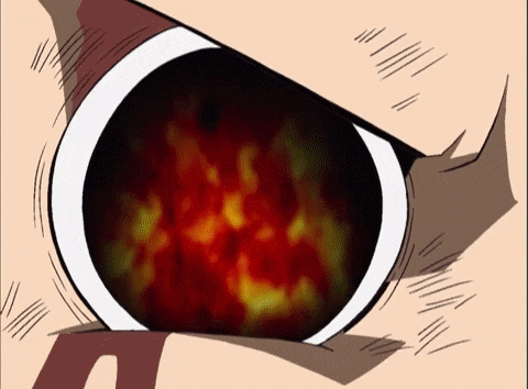 a close up of a person 's eye with a red and yellow flame coming out of it