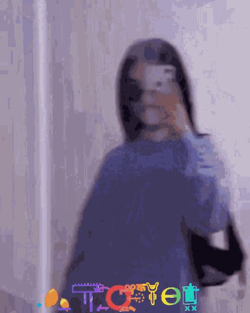 a blurry picture of a woman taking a picture of herself with the word tc on the bottom