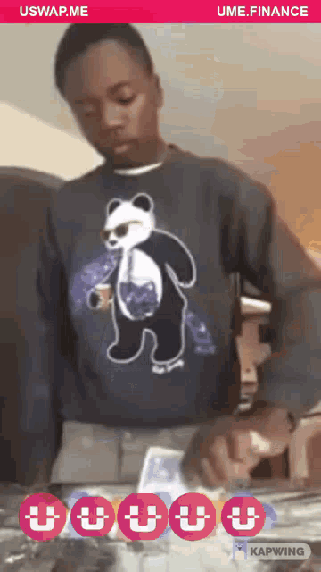 a man wearing a sweater with a panda on it