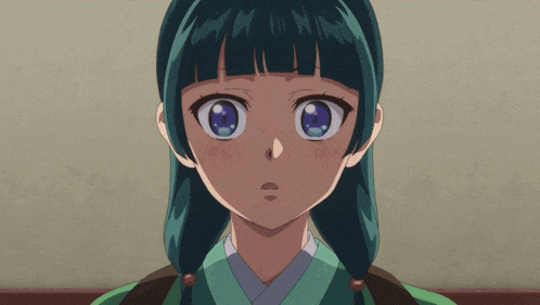 a close up of a girl 's face with a surprised look on her face