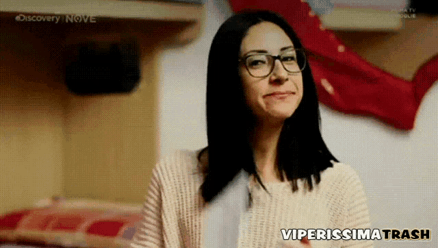 a woman wearing glasses and a sweater with the words viperissima trash on the bottom