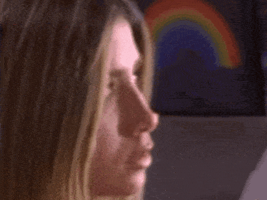 a close up of a woman 's face with a red nose