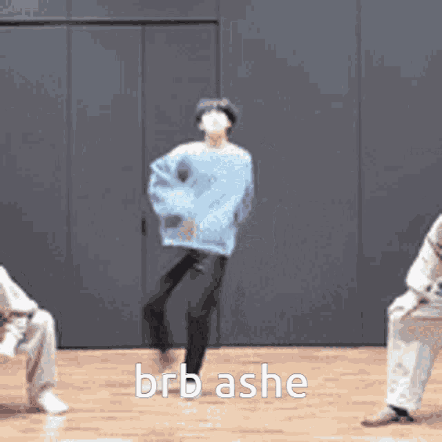 a group of people are dancing on a wooden floor and the words brb ashe are on the bottom of the image .
